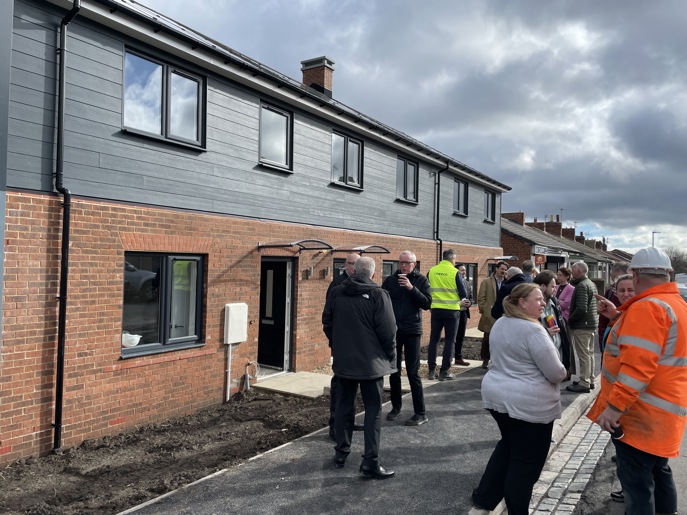 Visitors and contractors gather outside Eldon Street development