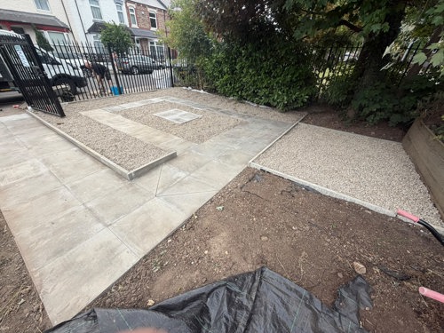 Area of community garden with new patio tiles and stoned areas